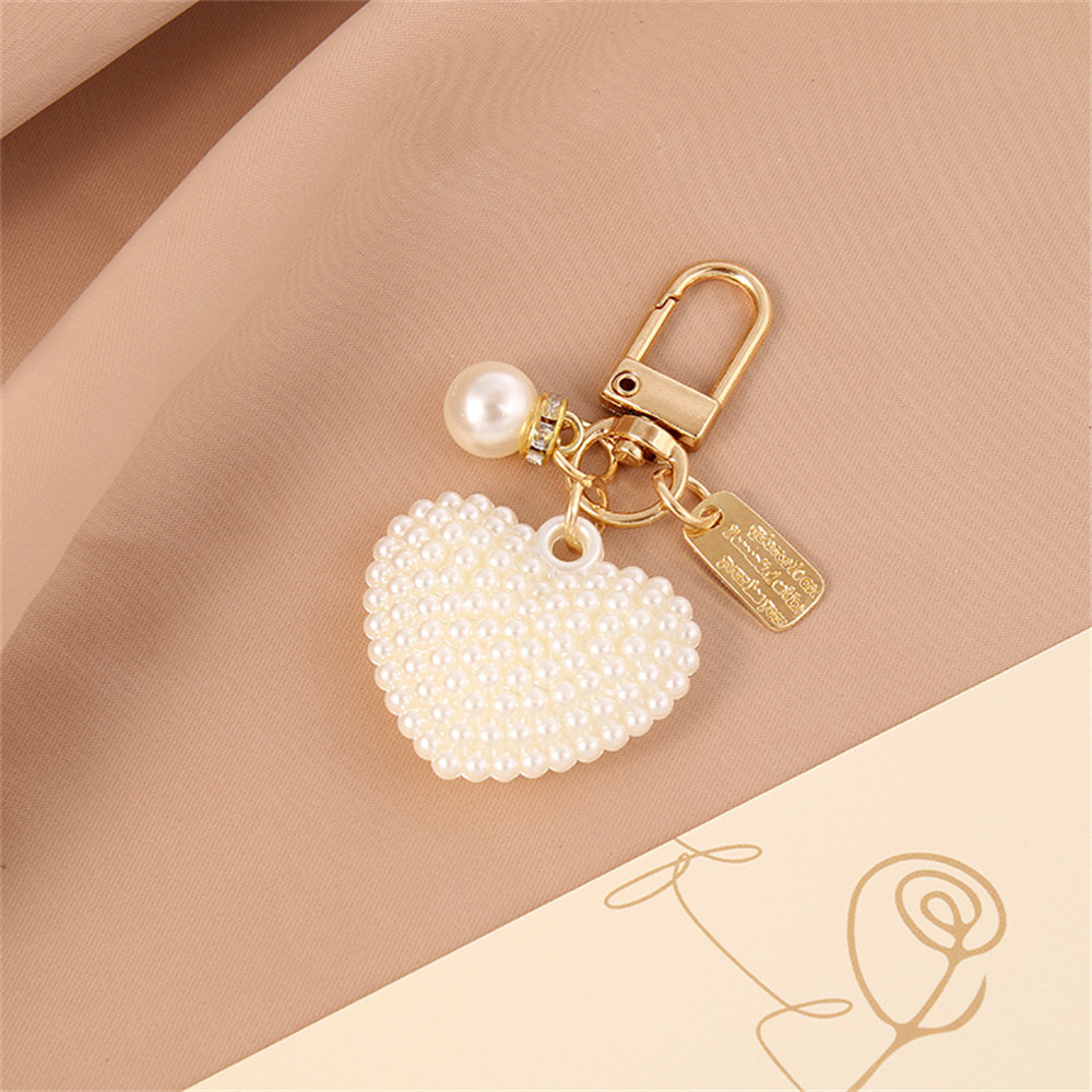 Picture of New Pearl Alloy Keychain Pendant Creative Pearl Hollow Love Accessories Bluetooth Headphone Box Bag Pendant
