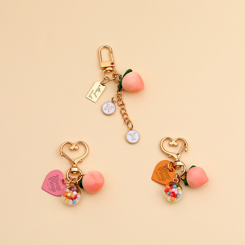 Cute peach keychain creative gift ball mobile phone key chain airpods pendant bag wholesale diy women