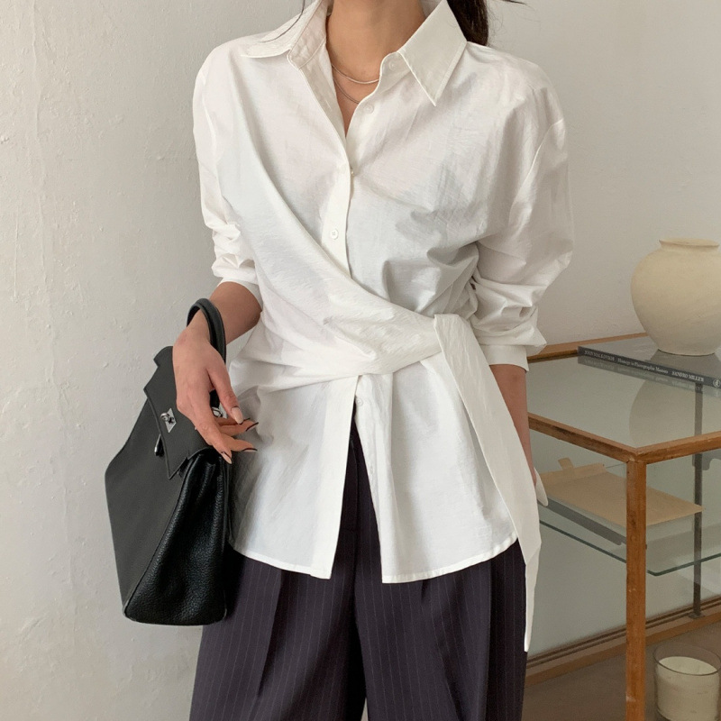 In stock, South Korea's Dongdaemun temperament design sense lapel single-breasted strap waist slimming long-sleeved shirt top