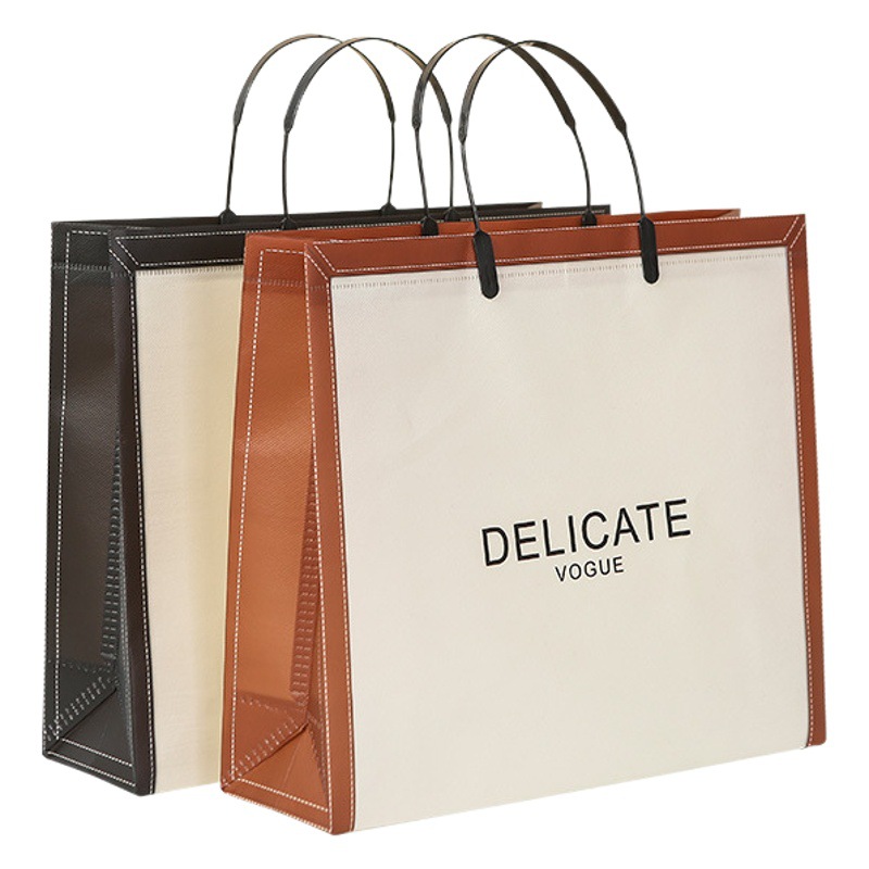 Custom portable high-end clothing store clothes bag packaging waterproof non-woven ear bag custom logo