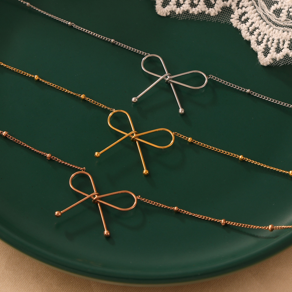 Italian magazine simple style clavicle chain titanium steel plated 18K real gold bracelet jewelry set bow necklace