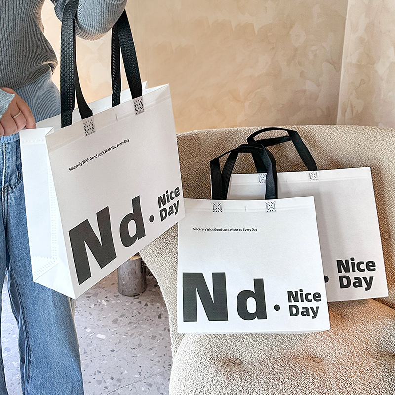 Clothing store new English film-coated shopping bag custom wholesale women's handbag clothes packaging bag gift bag