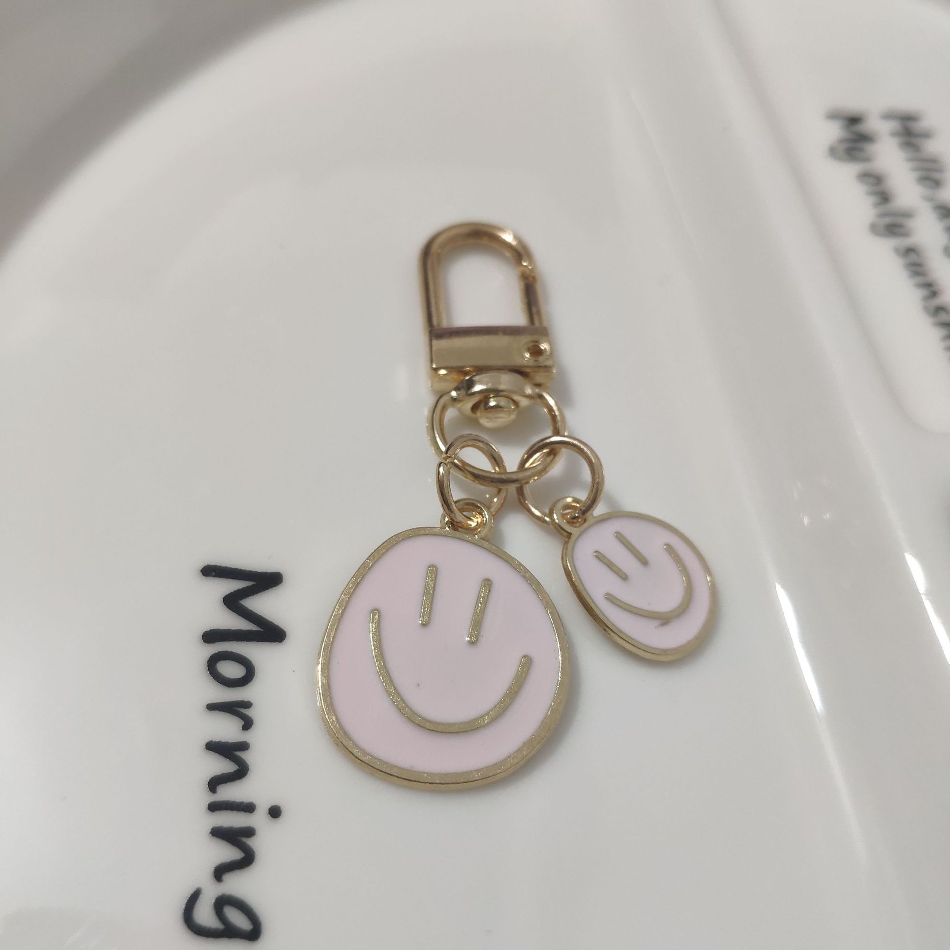 Picture of Cross-border e-commerce alloy color dripping smiley face keychain electroplated gold irregular expression bag pendant accessories