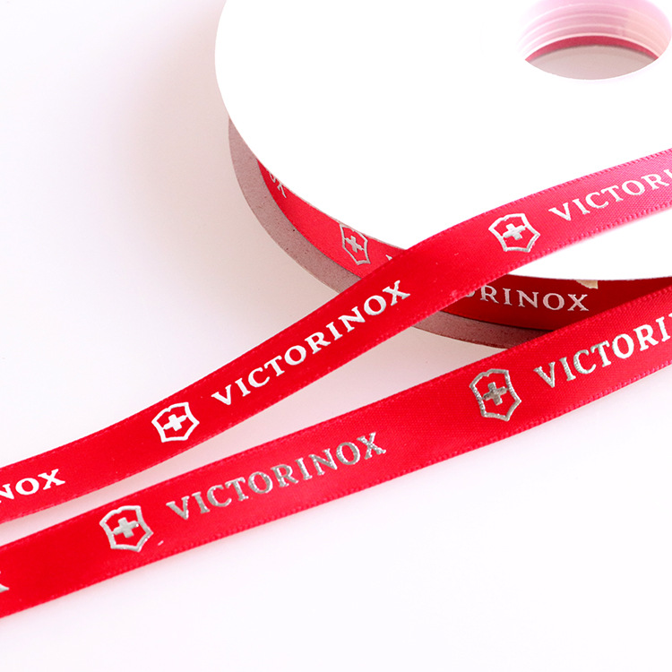 Picture of Make 2.5cm Board Hot-Fix Silver Ribbon Printing Logo English Letters Embossed Hot-Fix Silver Polyester Ribbon Printing