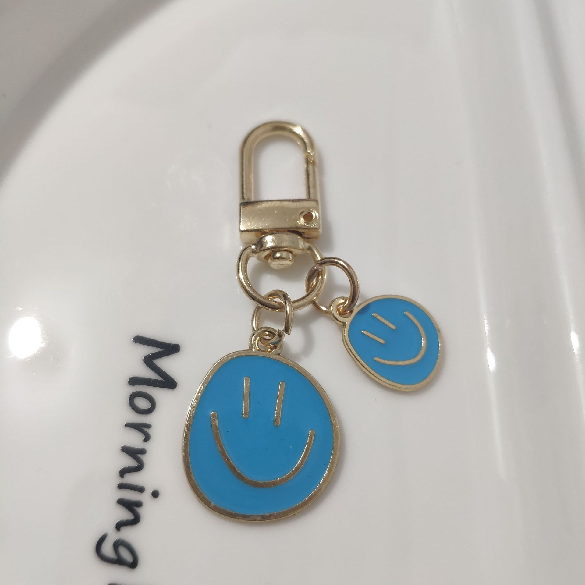 Picture of Cross-border e-commerce alloy color dripping smiley face keychain electroplated gold irregular expression bag pendant accessories