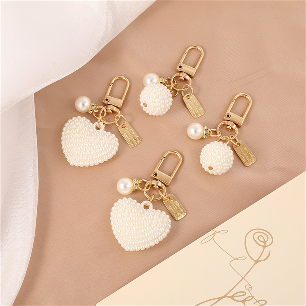 Picture of New Pearl Alloy Keychain Pendant Creative Pearl Hollow Love Accessories Bluetooth Headphone Box Bag Pendant