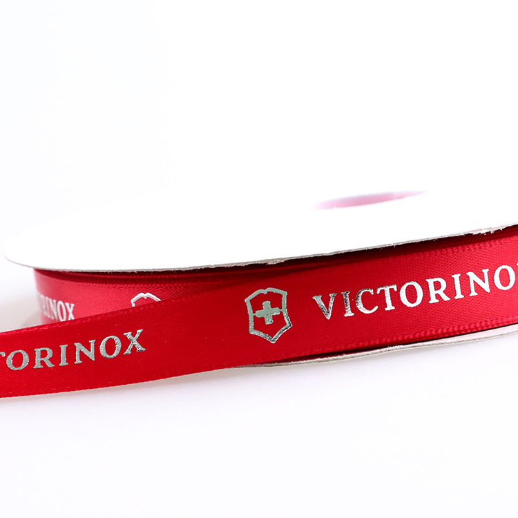 Make 2.5cm Board Hot-Fix Silver Ribbon Printing Logo English Letters Embossed Hot-Fix Silver Polyester Ribbon Printing