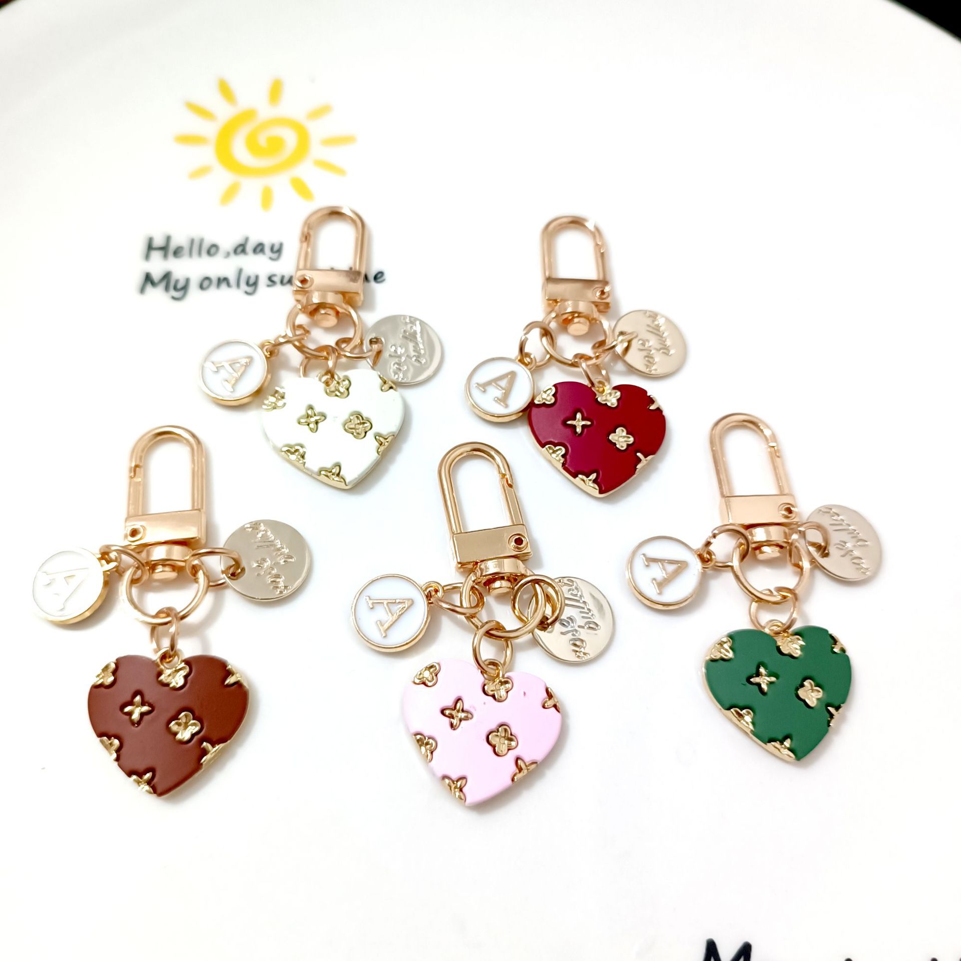 Cross-border alloy love key chain pendant creative hollow small flower letter round card accessories earphone set bag decoration