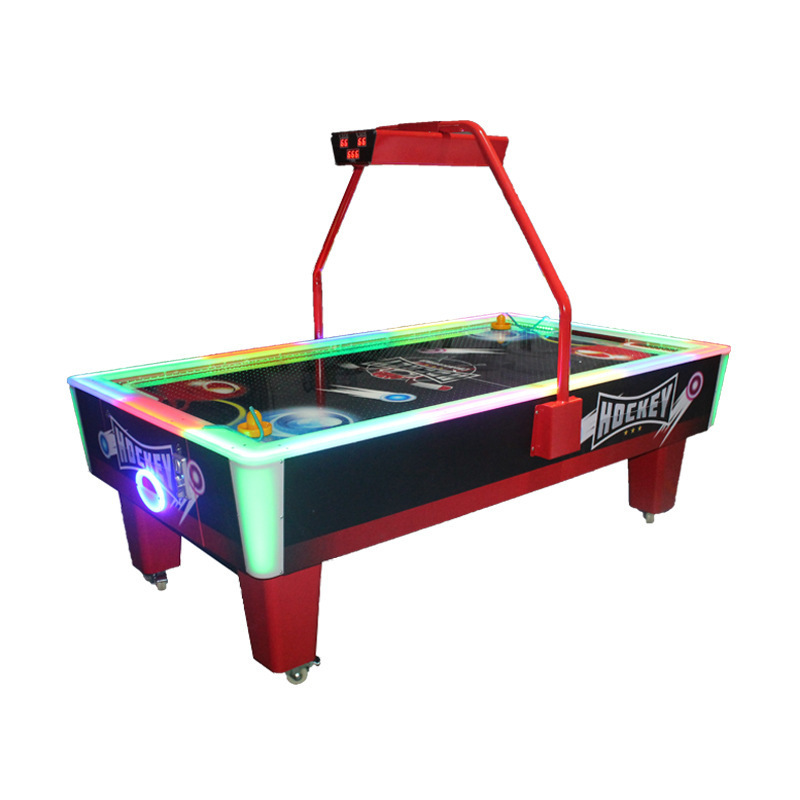 A large arcade commercial coin-operated double-player hockey machine with real competitive players, enjoying the fun of competition, and a popular model