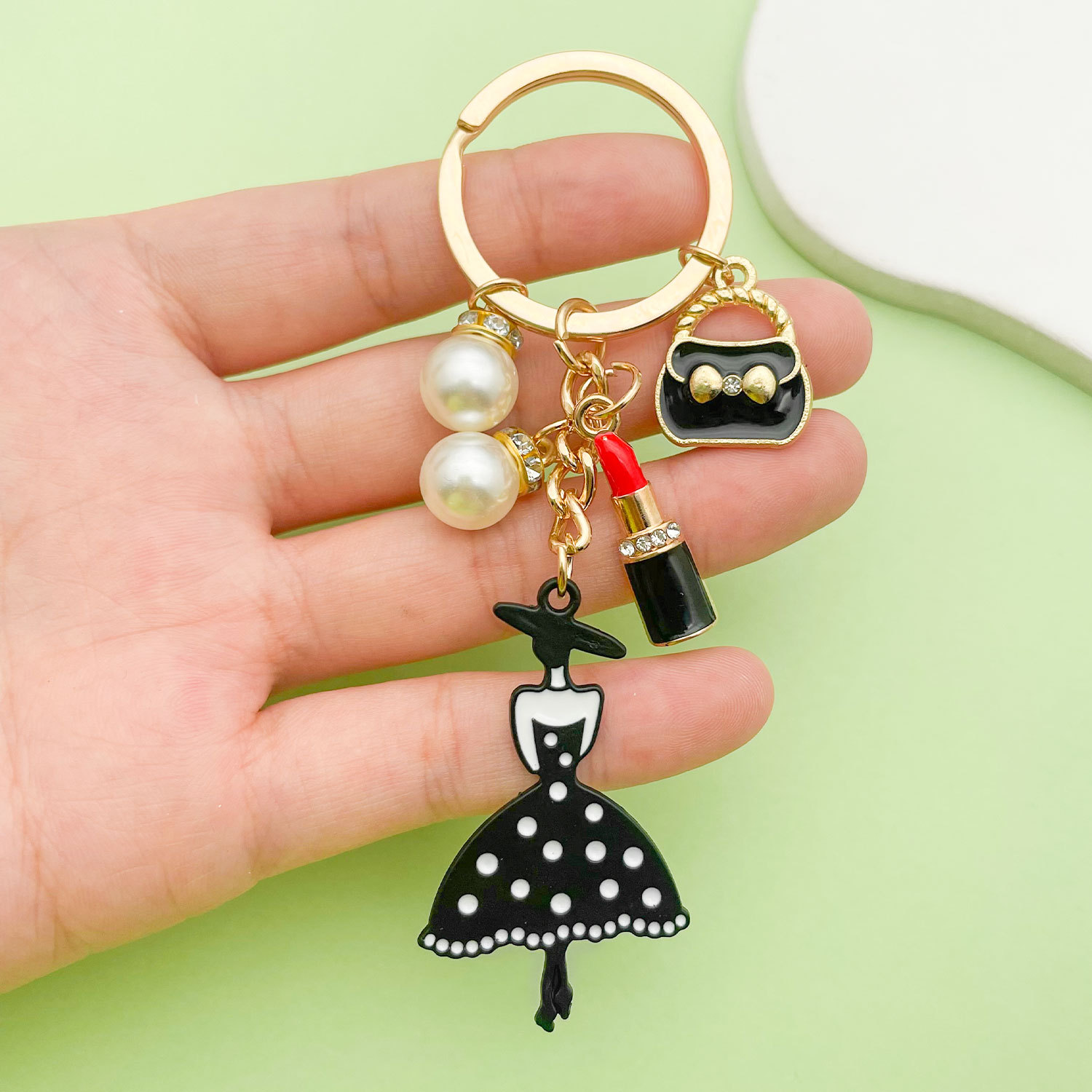 Cross-border Korean-style oil-dropping alloy black skirt lipstick pendant keychain pearl key chain ladies bag accessories