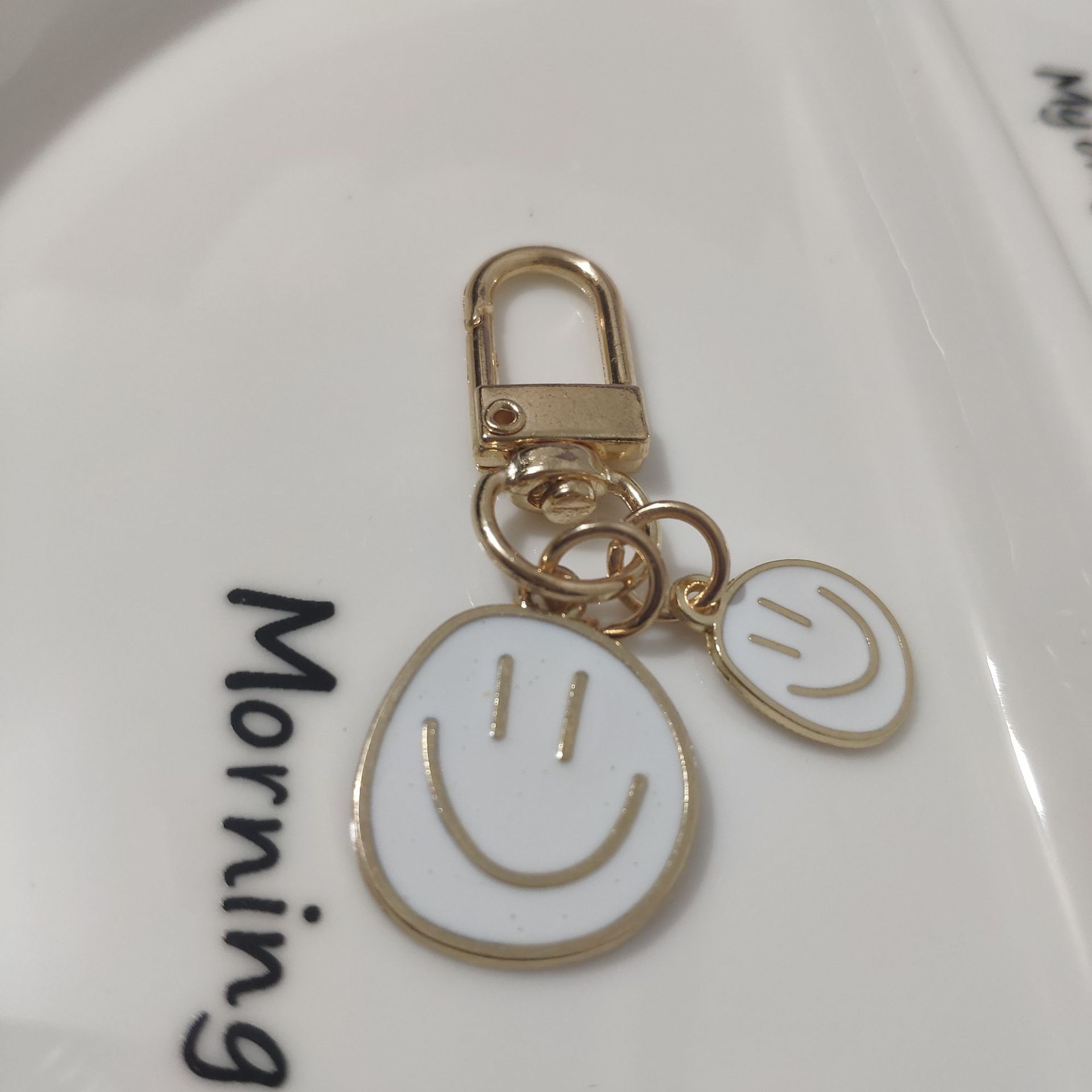 Picture of Cross-border e-commerce alloy color dripping smiley face keychain electroplated gold irregular expression bag pendant accessories