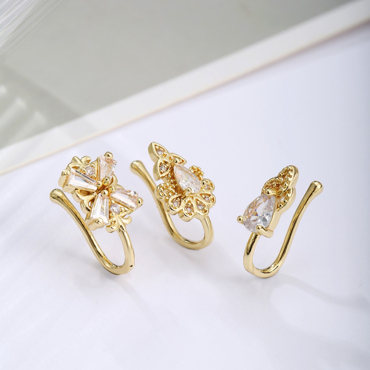 Picture of Exquisite and fashionable three-piece four-leaf clover copper plated real gold micro-inlaid zircon nose clip suit best-selling European and American nose combination