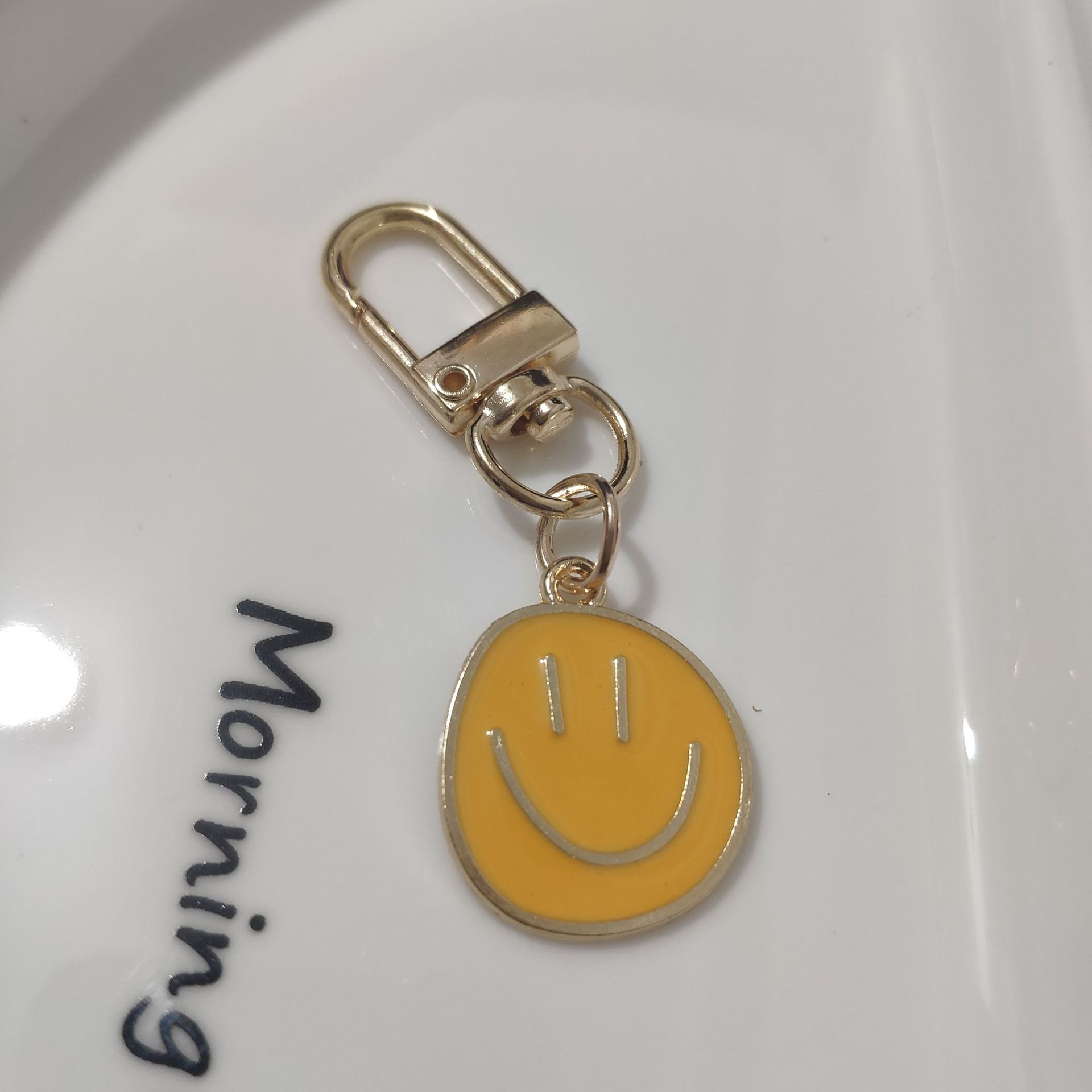 Picture of Cross-border e-commerce alloy color dripping smiley face keychain electroplated gold irregular expression bag pendant accessories