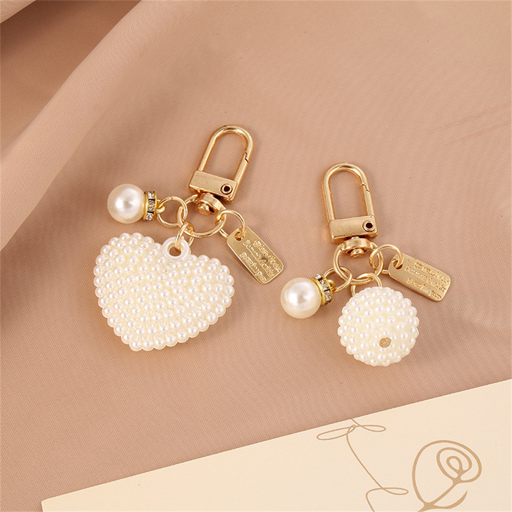 Picture of New Pearl Alloy Keychain Pendant Creative Pearl Hollow Love Accessories Bluetooth Headphone Box Bag Pendant