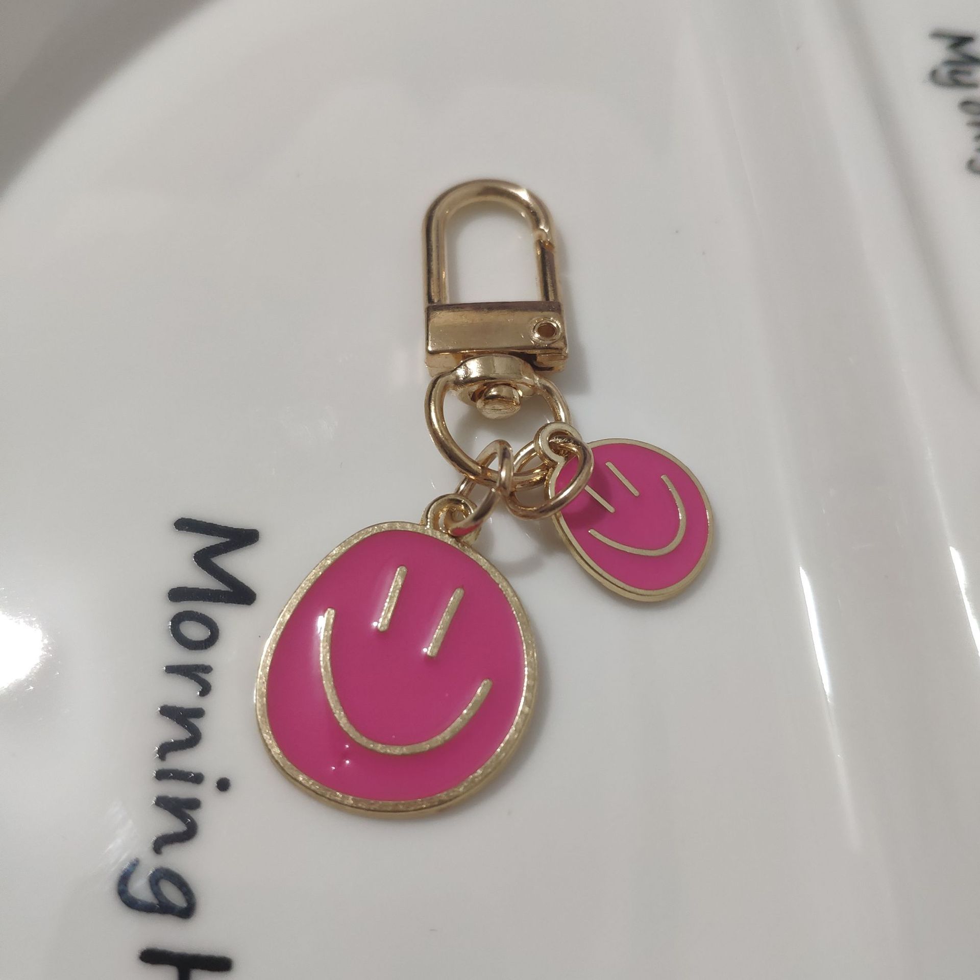 Picture of Cross-border e-commerce alloy color dripping smiley face keychain electroplated gold irregular expression bag pendant accessories